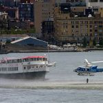 New York City Police helicopter hovers low over the Hudson River as it drops a police diver into the river